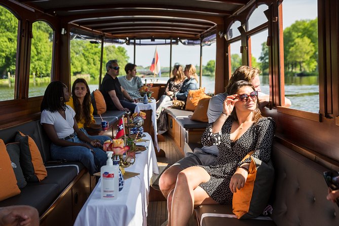 Amsterdam Classic Saloon Boat Cruise with Drinks and Cheese - Westerkerk, Carré, and the theater-and-church Amsterdam vibe