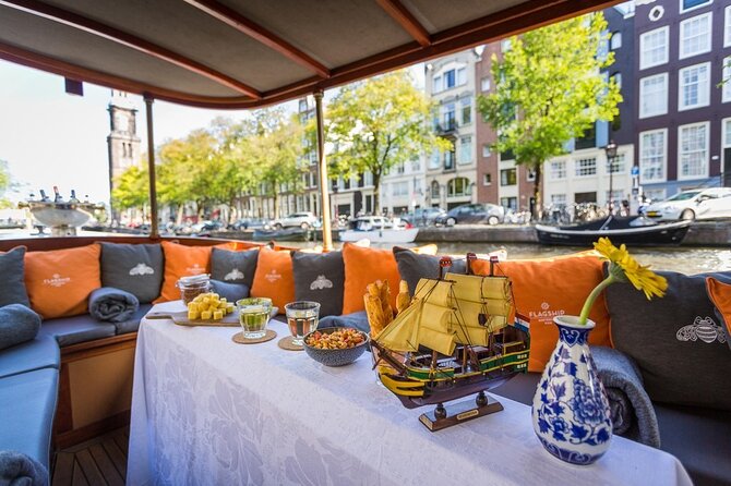 Amsterdam Small-Group Bike Tour With Canal Cruise, Drinks, Cheese - Prins Hendrik bust and the handoff to the canal cruise